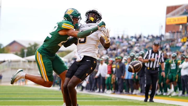 Baylor Bears cornerback Reggie Bush (22) breaks up the pass to UCF Knights wide receiver Waden Charles (19) during the second half at McLane Stadium Baylor Bears cornerback Reggie Bush (22) breaks up the pass to UCF Knights wide receiver Waden Charles (19) during the second half at McLane Stadium