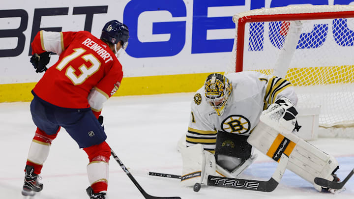 May 14, 2024; Sunrise, Florida, USA; Boston Bruins goaltender Jeremy Swayman (1) makes a save against Florida Panthers center Sam Reinhart (13) during the third period in game five of the second round of the 2024 Stanley Cup Playoffs at Amerant Bank Arena. Mandatory Credit: Sam Navarro-Imagn Images