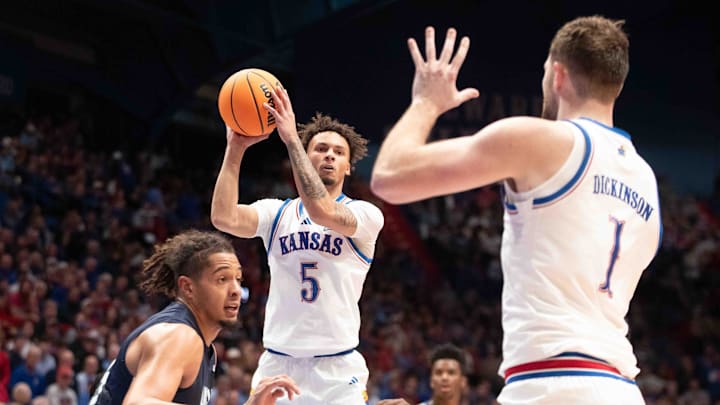 Kansas Jayhawks guard Zeke Mayo (5) looks to make a pass to Kansas Jayhawks center Hunter Dickinson (1) during the first half of the game inside Allen Fieldhouse Tuesday, Nov. 19, 2024.
