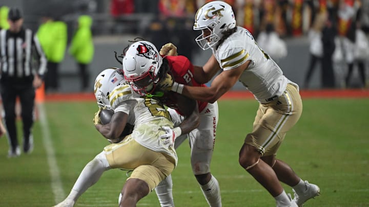 Nov 1, 2025; Raleigh, North Carolina, USA;  North Carolina State Wolfpack linebacker Elijah Groves (12) tackles Georgia Tech Yellow Jackets wide receiver Malik Rutherford (8) at Carter-Finley Stadium. Mandatory Credit: Zachary Taft-Imagn Images