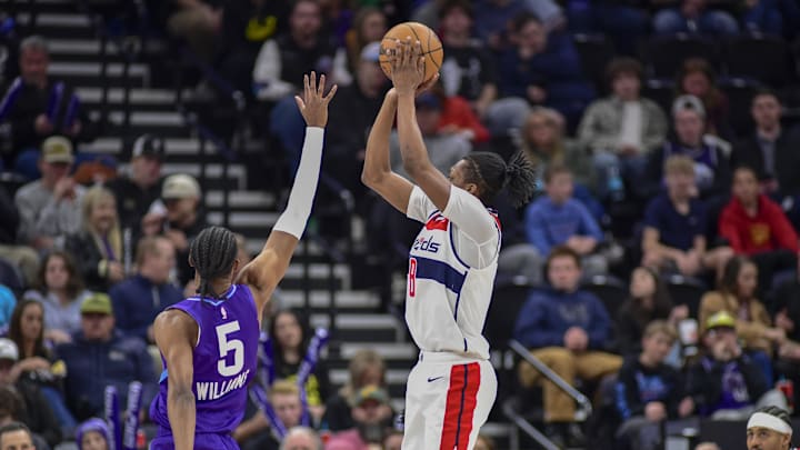 Mar 19, 2025; Salt Lake City, Utah, USA;  Washington Wizards guard Bub Carrington (8) attempts a three point basket against Utah Jazz forward Cody Williams (5) during the second half at the Delta Center. Mandatory Credit: Peter Creveling-Imagn Images