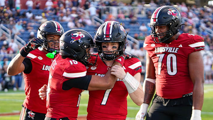 Dec 23, 2025; Boca Raton, FL, USA; Louisville Cardinals quarterback Miller Moss (7) and wide receiver Antonio Meeks (15) celebrate a touchdown pass against the Toledo Rockets during the third quarter of the Boca Raton Bowl at Flagler CU Stadium. Mandatory Credit: Jeff Romance-Imagn Images Dec 23, 2025; Boca Raton, FL, USA; Louisville Cardinals quarterback Miller Moss (7) and wide receiver Antonio Meeks (15) celebrate a touchdown pass against the Toledo Rockets during the third quarter of the Boca Raton Bowl at Flagler CU Stadium. Mandatory Credit: Jeff Romance-Imagn Images