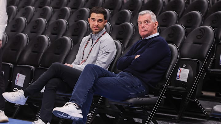 Atlanta Hawks owner Tony Ressler and son Nick Ressler talk before a game against the Chicago Bulls