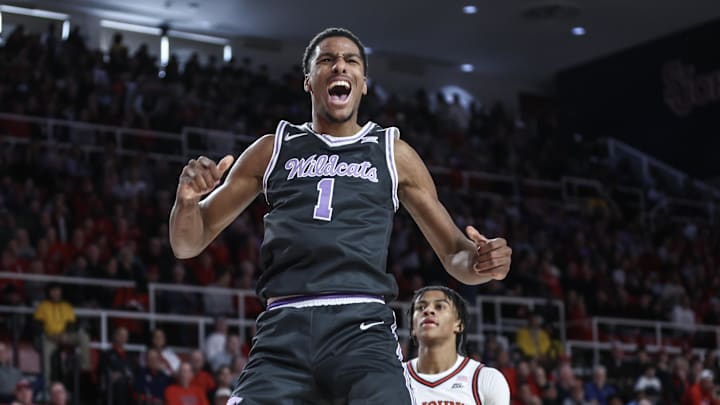 Dec 7, 2024; Queens, New York, USA;  Kansas State Wildcats guard David N'Guessan (1) celebrates after dunking in the first half against the St. John's Red Storm at Carnesecca Arena. Mandatory Credit: Wendell Cruz-Imagn Images