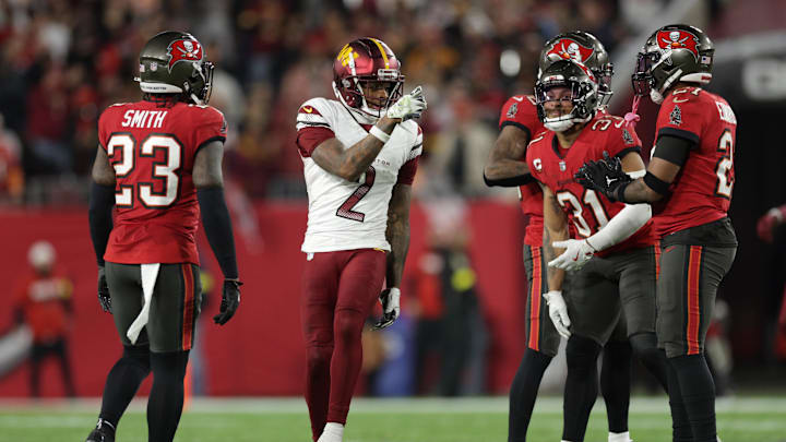 Jan 12, 2025; Tampa, Florida, USA; Washington Commanders wide receiver Dyami Brown (2) celebrates after a play in front of Tampa Bay Buccaneers safety Tykee Smith (23) and safety Antoine Winfield Jr. (31) during the fourth quarter of a NFC wild card playoff at Raymond James Stadium. 