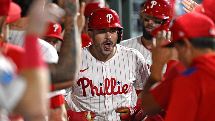 Sep 23, 2025; Philadelphia, Pennsylvania, USA; Philadelphia Phillies first base Otto Kemp (4) celebrates his two-run home run in the dugout during the second inning against the Miami Marlins at Citizens Bank Park. Mandatory Credit: Eric Hartline-Imagn Images