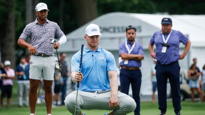Detroit Lions EDGE Aidan Hutchinson aims on the 14th green during AREA 313 Celebrity Scramble at Detroit Golf Club 
