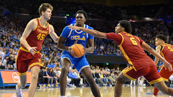 Feb 24, 2026; Los Angeles, California, USA; UCLA Bruins forward Xavier Booker (1) drives to the basket between Southern California Trojans center Gabe Dynes (45) and forward Jacob Cofie (6) during the second half at Pauley Pavilion presented by Wescom Financial. Mandatory Credit: Robert Hanashiro-Imagn Images Feb 24, 2026; Los Angeles, California, USA; UCLA Bruins forward Xavier Booker (1) drives to the basket between Southern California Trojans center Gabe Dynes (45) and forward Jacob Cofie (6) during the second half at Pauley Pavilion presented by Wescom Financial. Mandatory Credit: Robert Hanashiro-Imagn Images