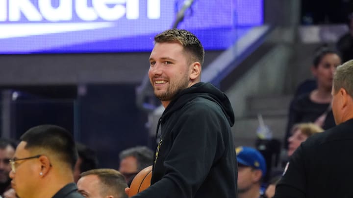 Oct 5, 2025; San Francisco, California, USA;  Los Angeles Lakers forward/guard Luka Doncic (77) smiles from the sidelines during the second quarter against the Golden State Warriors at Chase Center. Mandatory Credit: David Gonzales-Imagn Images