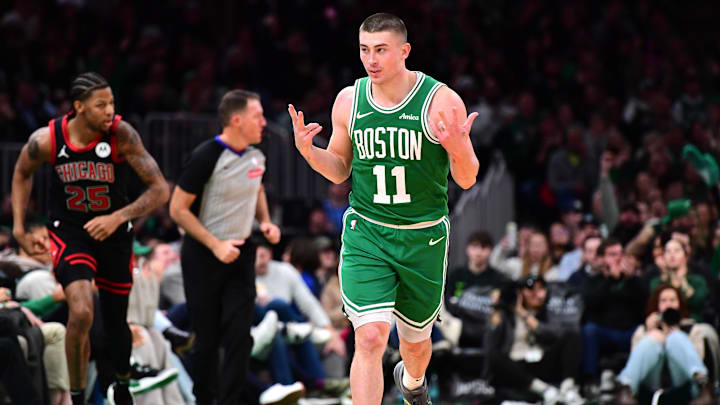 Jan 29, 2025; Boston, Massachusetts, USA; Boston Celtics guard Payton Pritchard (11) reacts after making a three pointer during the second half against the Chicago Bulls at TD Garden. 