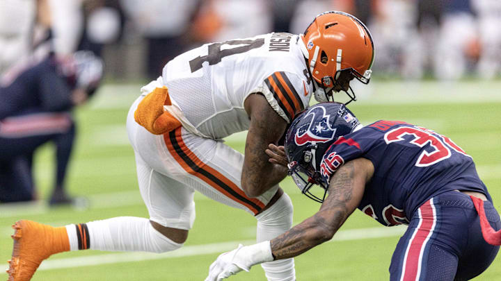 Dec 4, 2022; Houston, Texas, USA; Cleveland Browns quarterback Deshaun Watson (4) is tackled by Houston Texans safety Jonathan Owens (36) in the fourth quarter at NRG Stadium. Mandatory Credit: Thomas Shea-Imagn Images