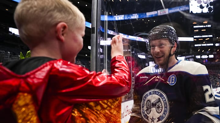 Oct 30, 2024; Columbus, Ohio, USA; Columbus Blue Jackets right wing Mathieu Olivier (24) greets his son in his halloween costume before the game against the New York Islanders at Nationwide Arena. Mandatory Credit: Samantha Madar-Imagn Images