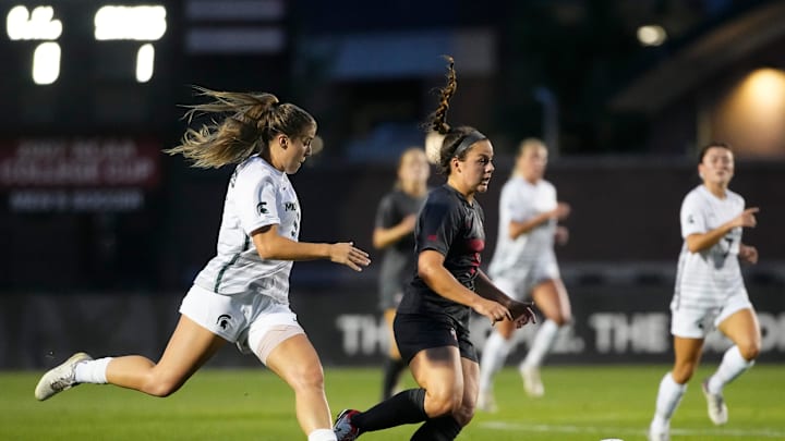 Sep 26, 2024; Columbus, Ohio, USA; Ohio State Buckeyes midfielder Amanda Schlueter (2) dribbles around Michigan State Spartans forward Meg Hughes (9) during the NCAA women's soccer game at Jesse Owens Memorial Stadium.