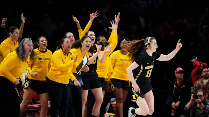 The Michigan Wolverines bench reacts to a shot from guard Syla Swords.