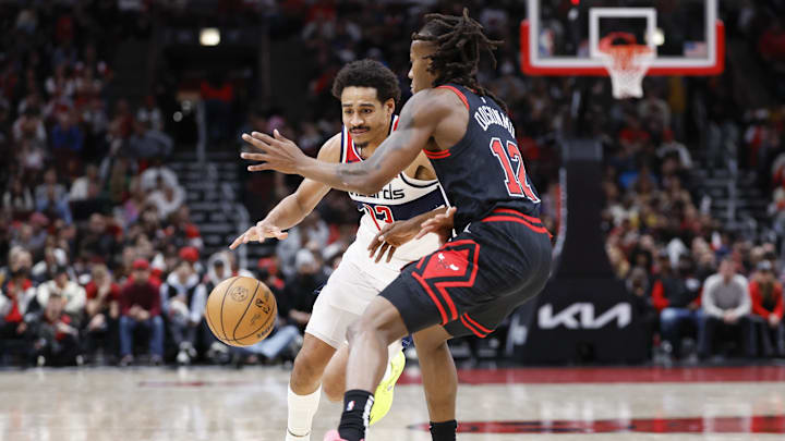 Mar 25, 2024; Chicago, Illinois, USA; Washington Wizards guard Jordan Poole (13) drives to the basket against Chicago Bulls guard Ayo Dosunmu (12) during the second half at United Center. Mandatory Credit: Kamil Krzaczynski-Imagn Images