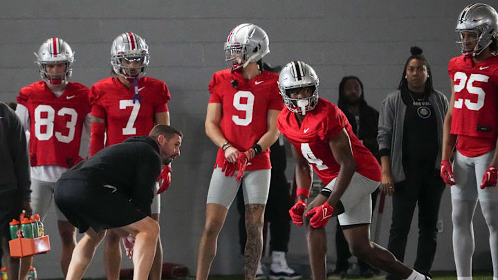 Mar 5, 2024; Columbus, OH, USA; Ohio State Buckeyes offensive coordinator Brian Hartline lines up beside wide receiver Jeremiah Smith (4) during the first spring practice at the Woody Hayes Athletic Center.