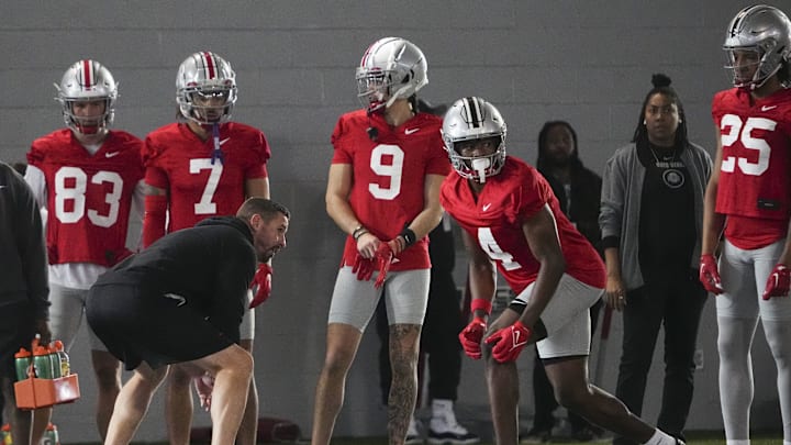 Mar 5, 2024; Columbus, OH, USA; Ohio State Buckeyes offensive coordinator Brian Hartline lines up beside wide receiver Jeremiah Smith (4) during the first spring practice at the Woody Hayes Athletic Center.