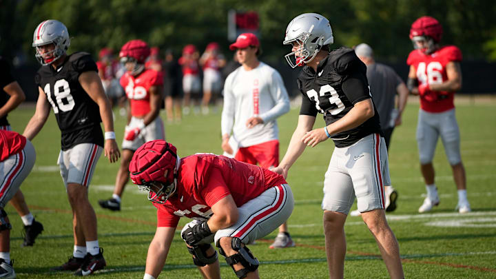 Aug 8, 2024; Columbus, Ohio, USA; Ohio State Buckeyes quarterbacks Will Howard (18) and Devin Brown (33) take snaps during football practice at the Woody Hayes Athletic Complex.
