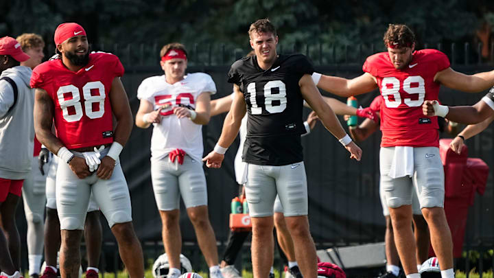 Aug 8, 2024; Columbus, Ohio, USA; Ohio State Buckeyes tight end Gee Scott Jr. (88) and quarterback Will Howard (18) stretch during football practice at the Woody Hayes Athletic Complex.