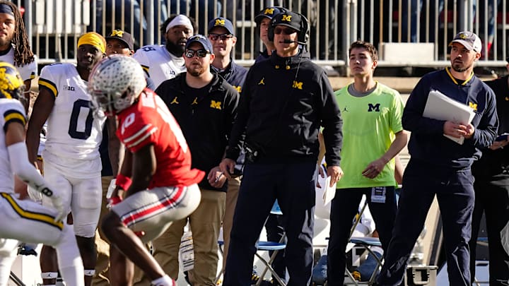 Nov 26, 2022; Columbus, Ohio, USA; Michigan Wolverines head coach Jim Harbaugh watches from the sideline beside off-field analyst Connor Stalions, right, during the NCAA football game against the Ohio State Buckeyes at Ohio Stadium.