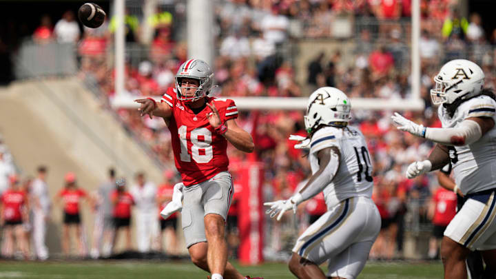 Aug 31, 2024; Columbus, OH, USA; Ohio State Buckeyes quarterback Will Howard (18) throws a pass over Akron Zips linebacker Antavious Fish (10) during the first half of the NCAA football game at Ohio Stadium.
