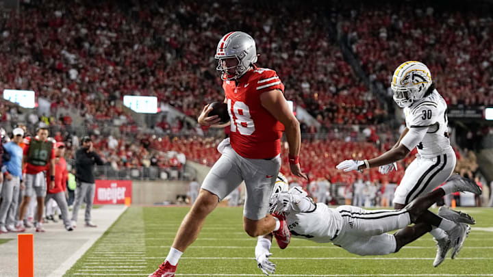 Sep 7, 2024; Columbus, Ohio, USA; Ohio State Buckeyes quarterback Will Howard (18) runs for a touchdown past Western Michigan Broncos cornerback Bilhal Kone (1) and safety Armani-Eli Adams (30) during the first half of the NCAA football game at Ohio Stadium.