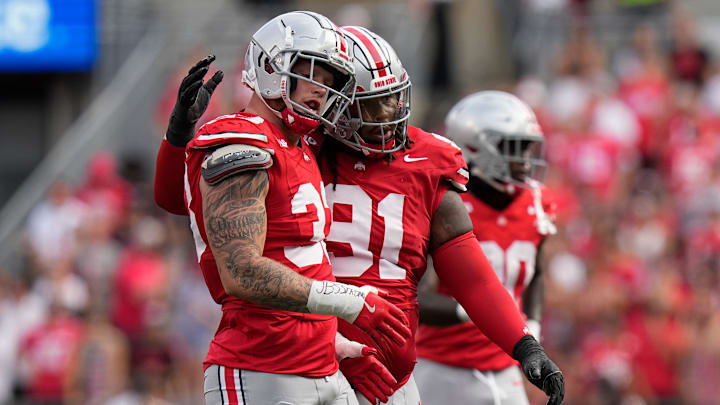 Aug 31, 2024; Columbus, OH, USA; Ohio State Buckeyes defensive end Jack Sawyer (33) gets a hug from defensive tackle Tyleik Williams (91) during the first half of the NCAA football game against the Akron Zips at Ohio Stadium.