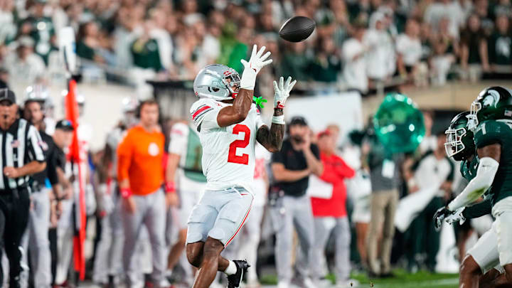 Sep 28, 2024; East Lansing, Michigan, USA; Ohio State Buckeyes wide receiver Emeka Egbuka (2) catches a pass against the Michigan State Spartans in the first half at Spartan Stadium on Saturday.