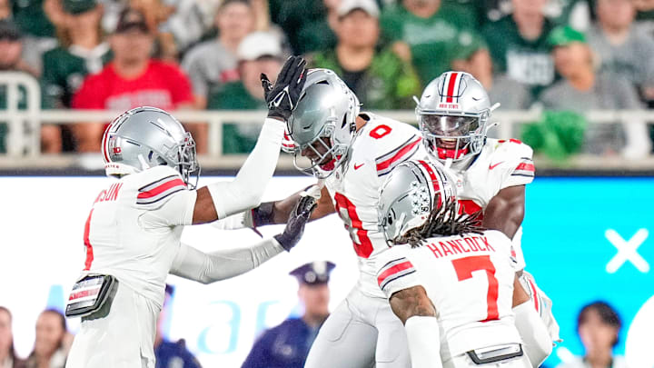 Sep 28, 2024; East Lansing, Michigan, USA; Ohio State Buckeyes linebacker Cody Simon (0) celebrates with teamates in the first half at Spartan Stadium on Saturday.