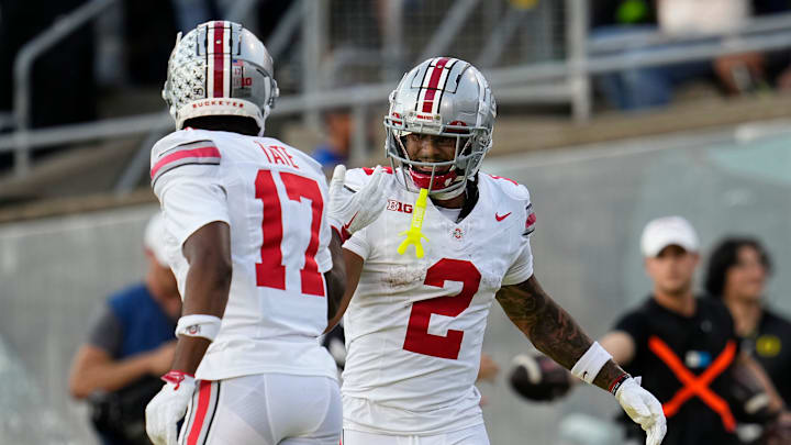 Oct 12, 2024; Eugene, Oregon, USA; Ohio State Buckeyes wide receiver Emeka Egbuka (2) celebrates a touchdown with wide receiver Carnell Tate (17) during the first half of the NCAA football game against the Oregon Ducks at Autzen Stadium