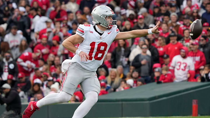 Ohio State Buckeyes quarterback Will Howard (18) makes a shovel pass during the second half of the NCAA football game against the Northwestern Wildcats at Wrigley Field in Chicago on Saturday, Nov. 16, 2024. Ohio State won 31-7.