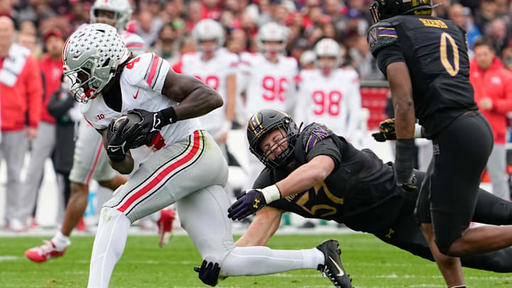 Ohio State Buckeyes wide receiver Jeremiah Smith (4) catches a pass in front of Northwestern Wildcats linebacker Greyson Metz (57) during the first half of the NCAA football game at Wrigley Field in Chicago on Saturday, Nov. 16, 2024.