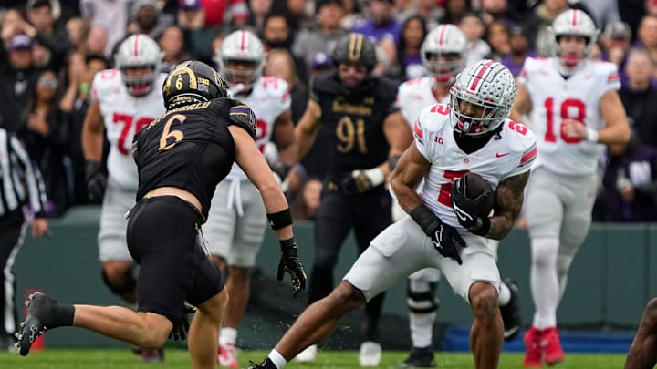 Ohio State Buckeyes wide receiver Emeka Egbuka (2) catches a pass in front of Northwestern Wildcats defensive back Robert Fitzgerald (6) during the first half of the NCAA football game at Wrigley Field in Chicago on Saturday, Nov. 16, 2024.