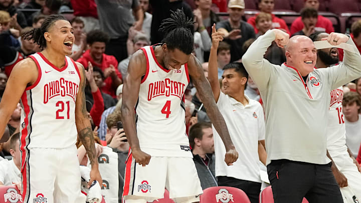 Ohio State Buckeyes forward Devin Royal (21), forward Aaron Bradshaw (4) and assistant coach Luke Simons react to a shot by center Ivan Njegovan during the second half of the NCAA men's basketball game against the Evansville Purple Aces at Value City Arena in Columbus on Tuesday, Nov. 19, 2024. Ohio State won 80-30.