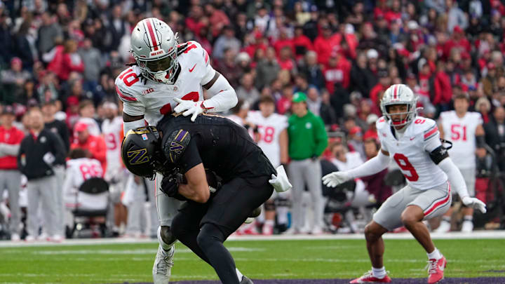 Ohio State Buckeyes cornerback Denzel Burke (10) tackles Northwestern Wildcats wide receiver Bryce Kirtz (17) during the NCAA football game at Wrigley Field in Chicago on Monday, Nov. 18, 2024. Ohio State won 31-7.