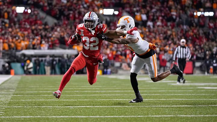 Ohio State Buckeyes running back TreVeyon Henderson (32) runs for a touchdown past Tennessee Volunteers defensive back Jalen McMurray (6) during the first half of the College Football Playoff first round game at Ohio Stadium in Columbus on Dec. 21, 2024.