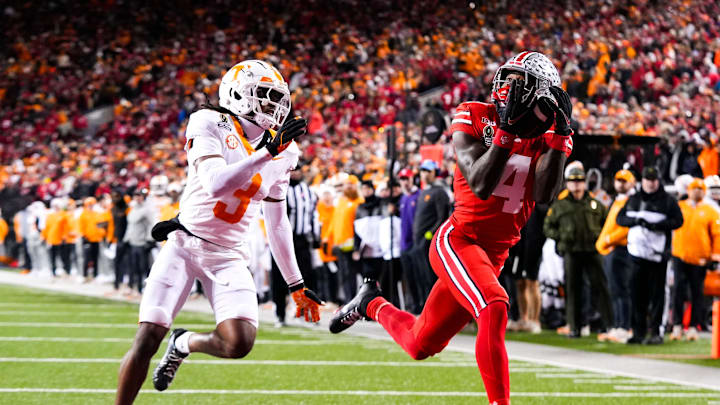 Ohio State Buckeyes wide receiver Jeremiah Smith (4) catches a touchdown pass against Tennessee Volunteers defensive back Jermod McCoy (3) in the second half at Ohio Stadium on Saturday, Dec. 21, 2024 in Columbus, Ohio.
