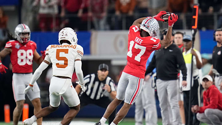 Ohio State Buckeyes wide receiver Carnell Tate (17) makes a sideline catch in front of Texas Longhorns defensive back Malik Muhammad (5) during the first half of the Cotton Bowl Classic College Football Playoff semifinal game at AT&T Stadium in Arlington, Texas on Jan. 10, 2025.