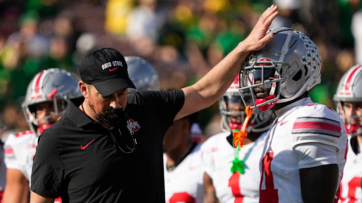 Ohio State Buckeyes head coach Ryan Day pats wide receiver Kojo Antwi (14) on the head during warm ups prior to the College Football Playoff quarterfinal against the Oregon Ducks at the Rose Bowl in Pasadena, Calif. on Jan. 1, 2025.