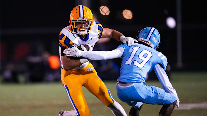 Olentangy's Kaden Gebhardt (34) runs the ball against Olentangy Berlin's Braylon Lopez (19) in the second half at Olentangy Berlin High School on Oct 25, 2024 in Delaware, Ohio.