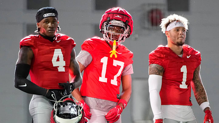 Ohio State Buckeyes wide receivers Jeremiah Smith (4), Carnell Tate (17) and Brandon Inniss (1) watch during spring football practice at the Woody Hayes Athletic Center on March 17, 2025.