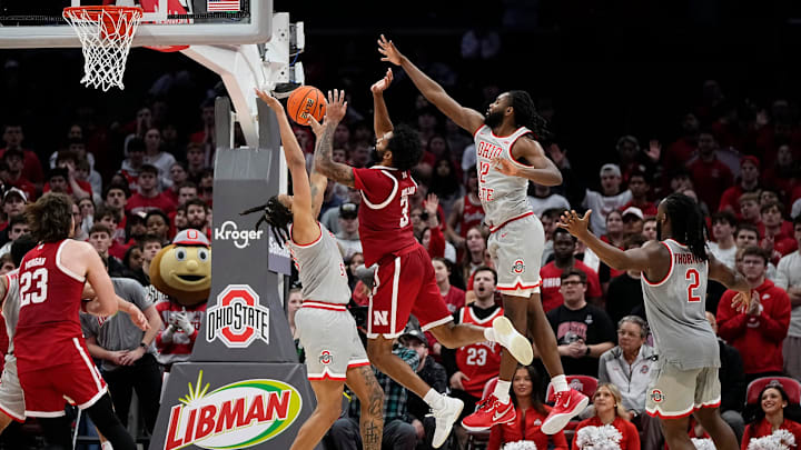 Ohio State Buckeyes forward Devin Royal (21) and guard Evan Mahaffey (12) defend Nebraska Cornhuskers guard Brice Williams (3) during the second overtime of the NCAA men's basketball game at Value City Arena in Columbus on March 4, 2025. Ohio State won 116-114.