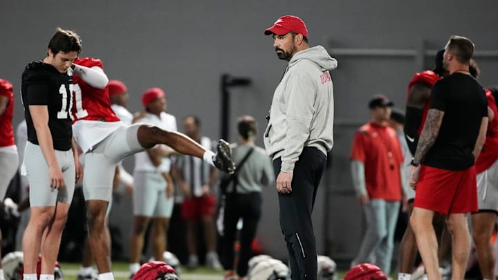 Ohio State Buckeyes head coach Ryan Day watches players stretch during spring football practice at the Woody Hayes Athletic Center in Columbus on March 19, 2025.