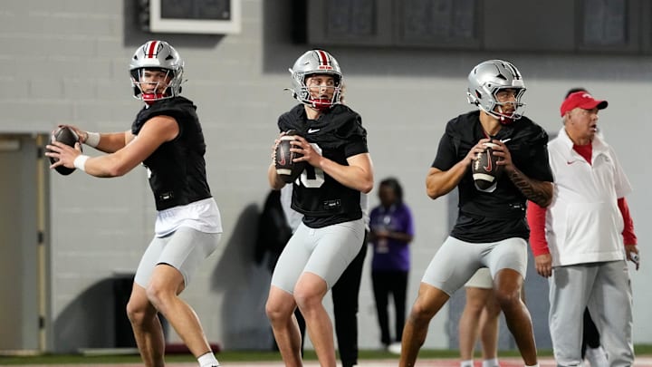 From left, Ohio State Buckeyes quarterbacks Lincoln Kienholz (3), Julian Sayin (10) and Tavien St. Clair (9) drop back to pass during spring football practice at the Woody Hayes Athletic Center in Columbus on March 19, 2025.