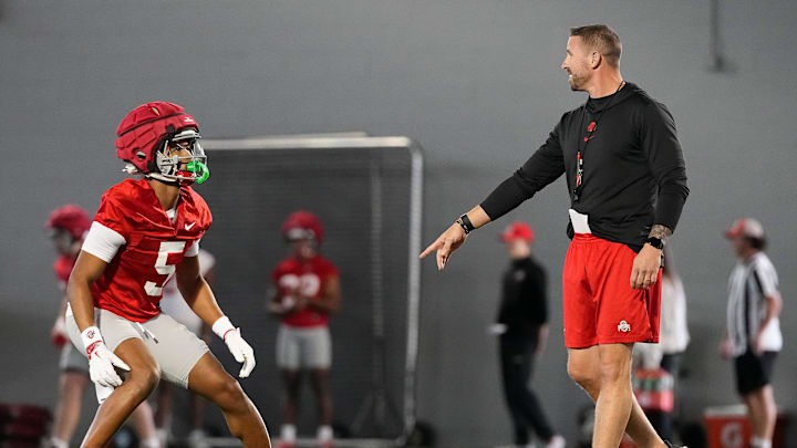 Ohio State Buckeyes offensive coordinator Brian Hartline works with wide receiver Mylan Graham (5) during spring football practice at the Woody Hayes Athletic Center on March 17, 2025.