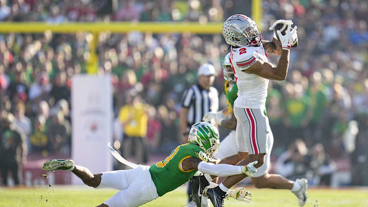 Ohio State Buckeyes wide receiver Emeka Egbuka (2) catches a pass over Oregon Ducks defensive back Nikko Reed (9) during the first half of the College Football Playoff quarterfinal at the Rose Bowl in Pasadena, Calif. on Jan. 1, 2025.