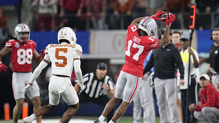 Ohio State Buckeyes wide receiver Carnell Tate (17) makes a sideline catch in front of Texas Longhorns defensive back Malik Muhammad (5) during the first half of the Cotton Bowl Classic College Football Playoff semifinal game at AT&T Stadium in Arlington, Texas on Jan. 10, 2025.