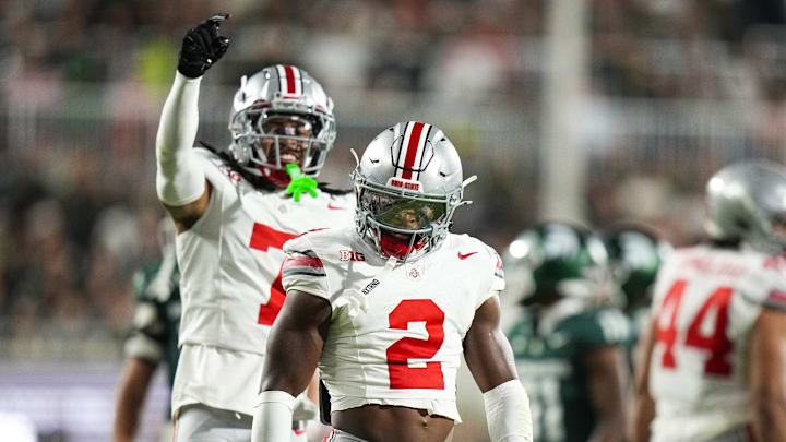 Sep 28, 2024; East Lansing, Michigan, USA; Ohio State Buckeyes safety Caleb Downs (2) celebrates after tackling Michigan State Spartans running back Nate Carter (5) in the first half at Spartan Stadium on Saturday.