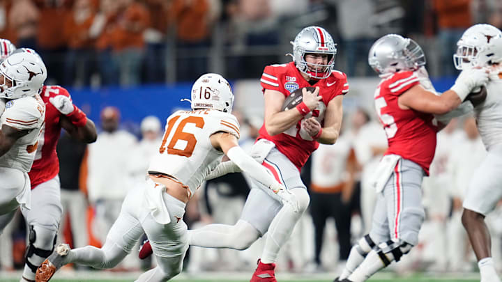Ohio State Buckeyes quarterback Will Howard (18) runs past Texas Longhorns defensive back Michael Taaffe (16) for a first down during the second half of the Cotton Bowl Classic College Football Playoff semifinal game at AT&T Stadium in Arlington, Texas on Jan. 10, 2025. Ohio State won 28-14.