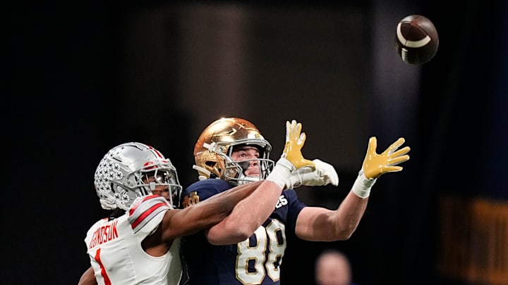 Ohio State Buckeyes cornerback Davison Igbinosun (1) attempts to break up a pass intended for Notre Dame Fighting Irish tight end Mitchell Evans (88) during the College Football Playoff championship at Mercedes-Benz Stadium in Atlanta on Jan. 20, 2025.